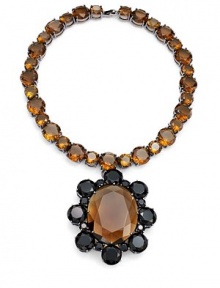 THE LOOKA dramatic look in two tones of bold faceted glassNecklace of brown, round faceted glass stonesFlower pendant with brown center framed by black petalsGunmetal prong settingFoldover claspTHE FITLength, about 17Pendant, about 3¼L X 2¾WTHE MATERIALGlassGunmetal platingORIGINImported