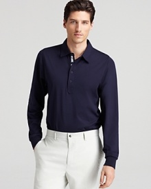 A classic-fit polo updated with long sleeves and rich hue, this versatile shirt effortlessly teams up with dress pants or jeans.