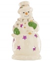 A shining star, this porcelain snowman figurine from Lenox features pierced accents filled with the light from within. Gold accessories add to its whimsical glow.