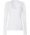 Stylish long sleeve t-shirt in white cotton - Super-soft, machine washable material - Flattering low V-neck with decorative trim - Relaxed slim cut with extra-long sleeves - Hits at hip - A genius basic ideal for layering beneath blazers and cardigans - Pair with denim or leather slim pants and style with scarves or colorful multi-strand necklaces