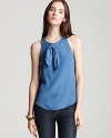 This flowing MARC BY MARC JACOBS silk top features a unique raw edge bow and the surprise of a back keyhole opening in a cloudless blue hue for gorgeous date night style.