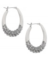 Uniquely upgraded. Hoop earrings may be a must-have for any casually chic jewelry collection, but this version from Kenneth Cole New York reveals a modern makeover. With a rounded oval silhouette and sparkling crystal accents, they're made in silver tone mixed metal. Approximate diameter: 1-1/4 inches.