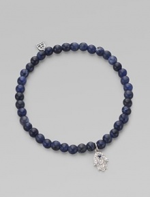 The hamsa, a traditional protective amulet, is encrusted with diamonds and accented with one sapphire as it hangs from a stretchy strand of deep-toned sodalite beads. Diamonds, 0.05 tcw Sodalite 14k white gold Diameter, about 2 (unstretched) Charm length, about ½ Imported