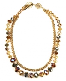 Add a splash of warm color this season. AK Anne Klein's double strand necklace incorporates smoky topaz-colored glass beads and gold tone chain detail secured by a toggle clasp. Crafted in gold tone mixed metal. Approximate length: 16 inches + 2-inch extender.