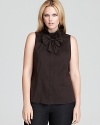 This Lafayette 148 New York sleeveless blouse features a ruffle neck and detachable bow. The perfect partner under a fitted jacket.