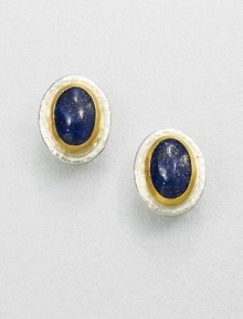 A beautiful, speckled lapis cabochon set in sterling silver and 24k gold. LapisSterling silver24k goldSize, about .9Post backImported 