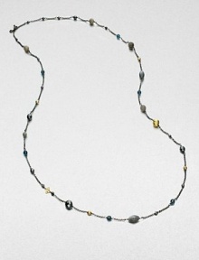 From the Bijoux Collection. Richly colored semi-precious stones in various colors and shapes mix with 18k gold beads on a delicate blackened sterling silver link chain. Hematite, labordarite, grey moonstone and blue topaz18k goldBlackened sterling silverLength, about 40Toggle closureImported 