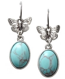 Organically appealing. Fossil's pretty earring design takes its cue from nature with oval-cut reconstituted turquoise stones and petite cut-out butterflies. Crafted in vintage silver tone mixed metal on fish wire. Approximate drop: 1-1/2 inches.