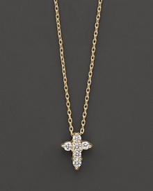 A diamond cross necklace in yellow gold. With signature ruby accent. Designed by Roberto Coin.