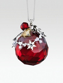 A cheery, faceted crystal sphere in holiday red, sweetly adorned with silvertone shapes and a tiny jingle bell.CrystalSilvertoneAbout 1.5H X 1.25WMade in Austria