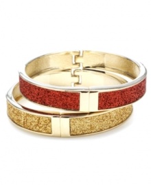 The perfect set of sparkle for the holidays! Betsey Johnson's glittering bangle set features a red and gold hinged bracelet that slips easily over the wrist. Set in gold tone mixed metal. Approximate diameter: 2-1/2 inches.