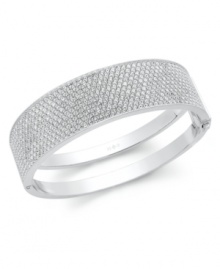 A modern bangle that shines with Swarovski touches. The slim silhouette is adorned with clear crystal pave accents. Complete with a hinged closure for a comfortable fit. Crafted in gray PVD mixed metal. Approximate diameter: 2-1/2 inches.