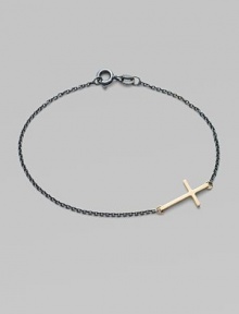 A gleaming 14k gold cross on an oxidized sterling silver chain.14k yellow gold Oxidized sterling silver Length, about 7 Pendant length, about ¾ Spring ring clasp Made in USA