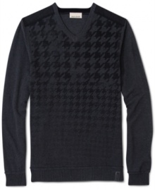 DKNY Jeans takes the traditional houndstooth pattern and the conventional V-neck sweater and turns them into something entirely new: A cotton knit printed with a houndstooth pattern that starts large (around the neck) and then gets smaller and smaller until it fades away (around the waist).