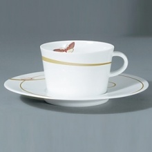 For over two centuries Raynaud has created unique Limoges porcelain, with a marked preference for relief shapes and generously colored and gilt decorations. Metamorphoses is a striking pattern of red and gold with a butterfly motif.