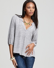 A polished Joie top with a smocked split neckline and pleat at the center tops off weekend denim with polished ease, replacing the off-duty tee with comfortable chic.