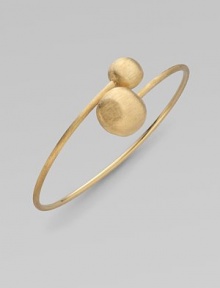 From the Africa Collection. Two textured orbs cross paths along a thin 18k yellow gold band.18k yellow gold Diameter, about 7 Made in Italy 