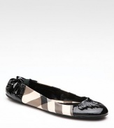 Sleek faux patent leather updates this classic Burberry check style. Leather/PVC upper Rubber sole Padded insole Made in ItalyOUR FIT MODEL RECOMMENDS ordering one half size up as this style runs small. 