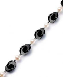 Striking contrast. Overlapping onyx discs (12 mm) combine with cultured freshwater pearls (6-1/2-7 mm) for a bold and elegant look. Set in sterling silver. Approximate length: 7-1/2 inches.