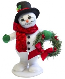 Winter gets a warm welcome with this cozy Christmas snowman. Standing on his own two feet, he greets the season in a velvety red scarf and black top hat. With the soft features and unmistakable style of Annalee dolls.