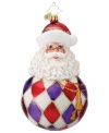 Santa Claus melds with a classic Christmas ball in this lovely hand-painted glass ornament from Christopher Radko to add some joy to your tree this holiday season.