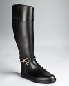 In a riding boot silhouette, Moschino Cheap and Chic's bow-detailed rain boots lend a smart, equestrian look to days with unfavorable weather.