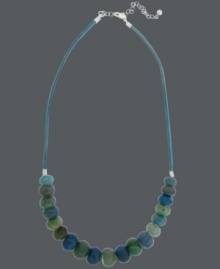 Ocean hues. Avalonia Road's destination-inspired necklace features teal and green fire agate beads (32 ct. t.w.) strung from a blue cord. Clasp and extension chain crafted from sterling silver. Approximate length: 18 inches + 2-inch extender.