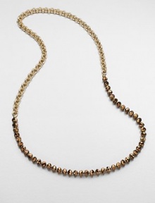 An artistic design with faceted beads on a double link chain. Glass beadsGoldtone brassLength, about 35Slip-on styleImported 