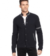 A button-front cardigan that quotes the collegiate with armband and color-tipped handwarmer pockets, from Armani Jeans.