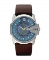 Seamlessly marrying modern and traditional aesthetics, this Diesel watch plays well with a wide range of personal styles. Brown leather strap and round stainless steel case, 45x27mm. Bezel engraved with logo at three o'clock. Blue sunray dial featuring a matte texture with printed and applied stick indices, numeral at twelve o'clock, day and date window at three o'clock and yellow accents. Quartz movement. Water resistant to 100 meters. Two-year limited warranty.