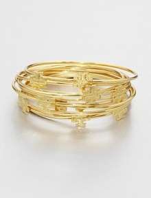 Stacked set of ten bangles with goldplated logo medallions for a simple, layered look. 16K goldplated brassDiameter, about 2½Slip-on styleImported