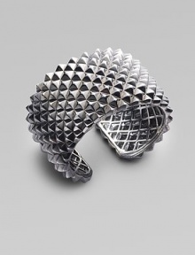 A dramatic cuff design, with a stud-like texture and a stunning finish of black rhodium over sterling silver. Black rhodium-finished sterling silver Diameter, about 2½ Width, about 1¾ Hinged Imported