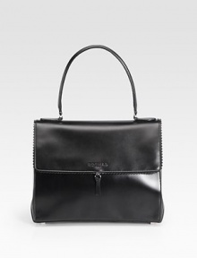 Sumptuously-sleek leather in a demure flap silhouette, edged with scalloped trim.Top handle, 6½ dropMagnetic snap flap closureProtective metal feetOne inside zip pocketOne inside open pocketLeather lining11¾W X 9½H X 5¾DMade in Italy