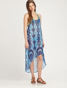 This voluminous, semi-sheer style features a bright ikat print and an asymmetrical hem. ScoopneckSleevelessRacerbackContrast pipingAsymmetrical hemAbout 50 from shoulder to hemPolyesterHand washMade in USA of imported fabrics