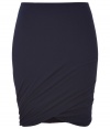 Sumptuously soft and effortlessly elegant, Donna Karans pure, ink blue cashmere knit skirt epitomizes understated luxury - Curve-hugging, medium-rise pull on style with hidden elasticated waist - Gorgeous signature drape and twist detail at hem - A chic go-to in any wardrobe perfect for pairing with cashmere pullovers, silk tops or button downs and ankle booties or platform pumps