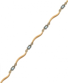 Cool blue. Victoria Townsend's stunning bracelet combines oval-cut blue topaz (1-5/8 ct. t.w.) and diamond accents in 18k gold over sterling silver. Approximate length: 7-1/4 inches.