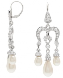 Glittering and gorgeous. Showcasing sparkling Swarovski crystals, Monet's elegant chandelier earrings are further adorned with glass accents and imitation pearls. They're an exquisite finishing touch for any evening ensemble. Set in silver tone mixed metal, they include sterling silver earwires. Approximate drop: 1-1/2 inches.