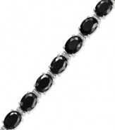 Stand out. Oval-cut onyx gemstones (18-3/4 ct. t.w.) and sparkling diamond accents adorn this chic bracelet. Crafted in sterling silver. Approximate length: 7-1/2 inches.