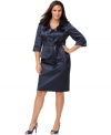 This shimmering plus size satin skirt suit by Nine West is elevated even more by a chic jacket with a ruffled neckline and a cutaway hem.