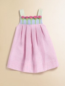 This beautiful seersucker frock is adorned with pastel-hued stripes and a row of pretty tulips.Square neckline with rosettesWide strapsBack zipperPleated empire waist55% cotton/45% polyesterMachine washImported