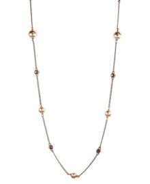 Delicately decorated with mocha glass pearls and smokey quartz-hued crystals, Givenchy's single-strand long necklace epitomizes understated elegance. Crafted in brown gold tone mixed metal. Approximate length: 36 inches.