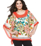 A vibrant burst of color and a flowing cut make ECI's poncho your new go-to top!