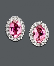 Express your femininity with pretty pink studs. Earrings feature a royalty-inspired look with oval-cut pink tourmaline (9/10 ct. t.w.) and a halo of round-cut diamonds (1/8 ct. t.w.) set in 14k white gold. Approximate diameter: 1/4 inch.