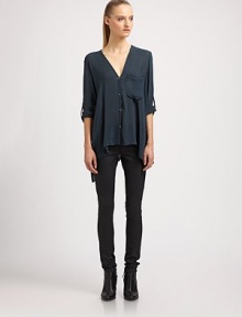 Nothing short of elegant, this featherweight shirt is designed with roll-tab sleeves and an asymmetrical cropped front hem. V-neckRoll-tab sleevesButton frontSingle front patch pocketAsymmetrical cropped front hemViscoseDry cleanImportedSIZE & FITModel shown is 5'10 (177cm) wearing US size Small. 