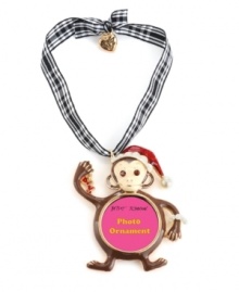 Monkey business. A cute chimp decked out in a Santa hat adorns Betsey Johnson's picture frame ornament. Crafted in gold tone mixed metal, it's embellished with crystal accents and a bow detail. Hangs from a gingham ribbon. Approximate length: 2-3/4 inches. Approximate drop: 4-1/4 inches.