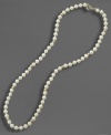 A dash of regal elegance, fit for the little lady. This simulated pearl necklace is studded with 14k gold beads and measures approximately 15 inches long.