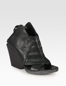 Futuristic leather design with an open front and comfortable elastic straps. Stacked wedge, 4 (100mm)Stacked platform, ½ (15mm)Compares to a 3½ heel (90mm)Leather and elastic upperLeather lining and solePadded insoleMade in ItalyOUR FIT MODEL RECOMMENDS ordering one size up as this style runs small. 