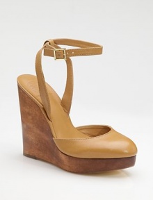 A richly stained wood wedge and platform sit underneath a leather sandal with a shapely closed toe and slender ankle strap.Wood wedge, 5½ (140mm) Wood platform, 1 (25mm) Compares to a 4½ heel (115mm) Buckle ankle strap Leather lining and sole Padded insole ImportedOUR FIT MODEL RECOMMENDS ordering one half size up as this style runs small. 