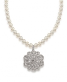 A glamorous floral pendant features a glittering array of crystals on this necklace from Carolee. Crafted with glass pearls and set in silver tone mixed metal. Approximate length: 18 inches + 2-inch extender. Approximate drop: 2 inches.