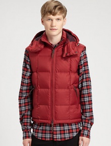 A warm, quilted silhouette and a removable drawstring hood adds a city-cool look to this military-inspired down vest for a relaxed, refined style that will remain season after season.Two-way frontRemovable drawstring hoodSide zip pocketsAbout 26 from shoulder to hemNylonDry cleanImported